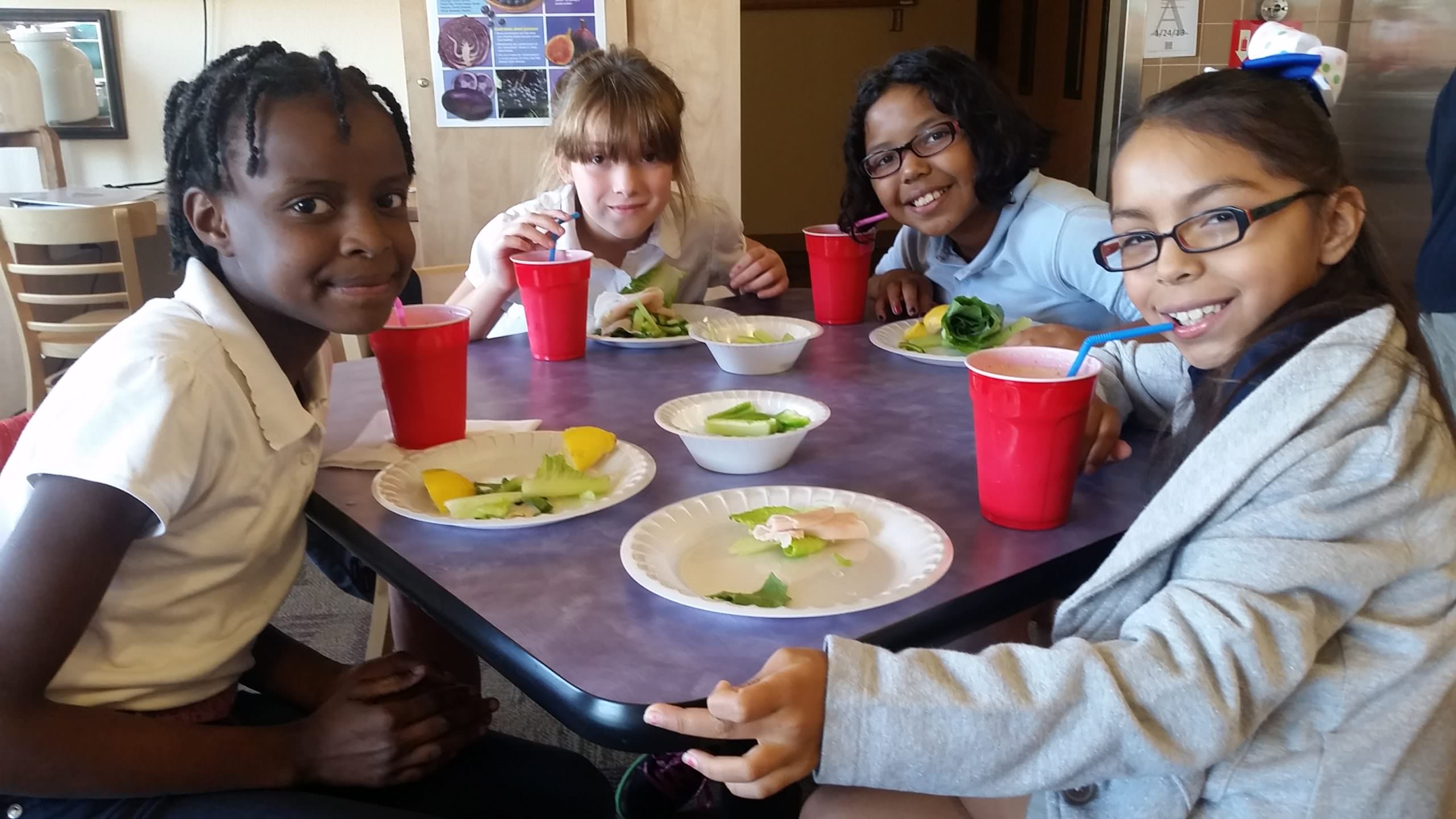 Group of children eating together with healthy choices.