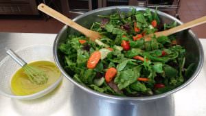A large bowl of healthy salad full of greens