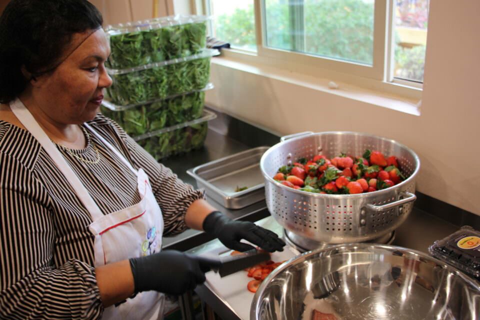Lady slicing strawberries